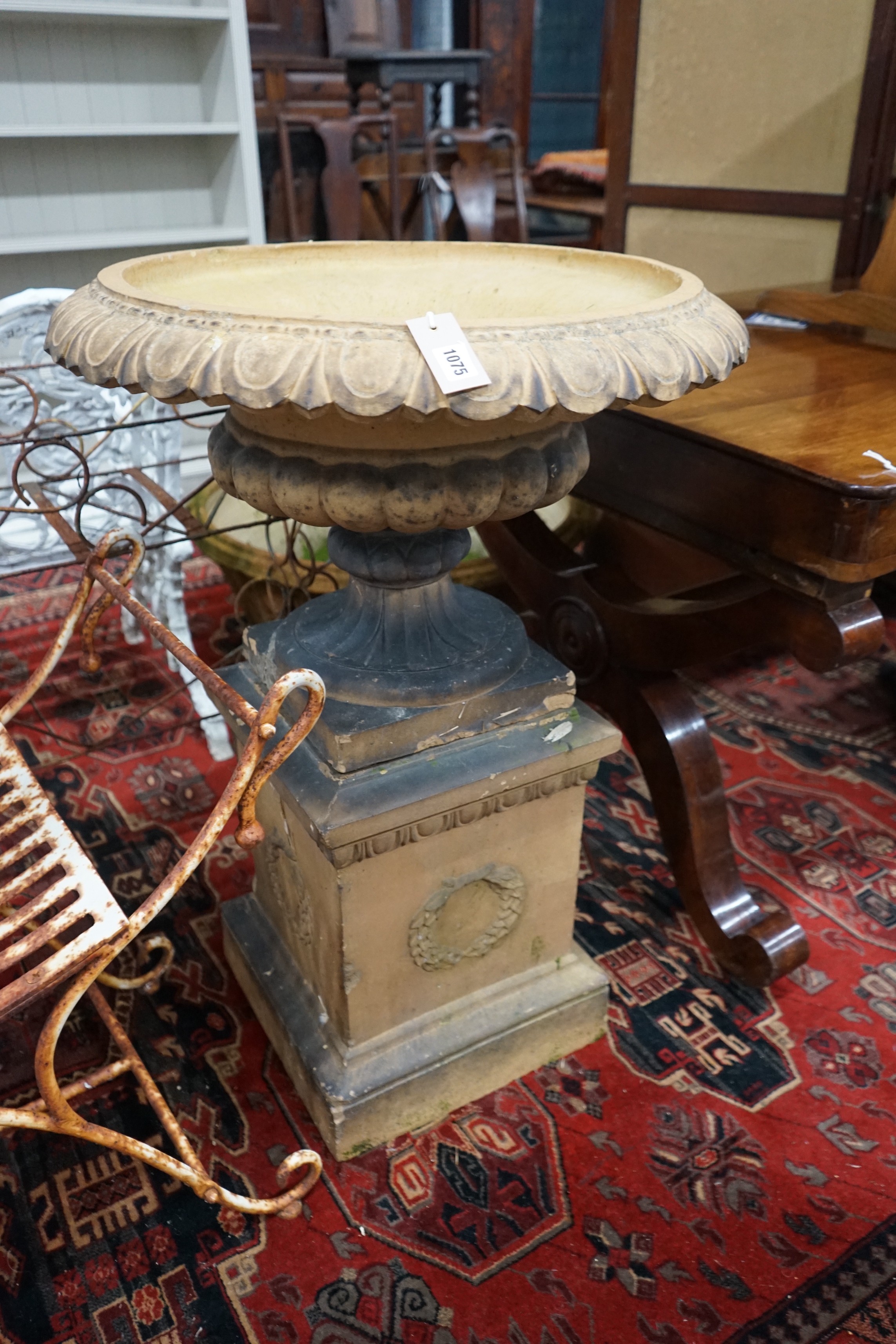 A Victorian earthenware campana garden urn on a plinth base, diameter 64cm, height 90cm